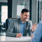 Man having a business meeting and signing a contract, recruitment or agreement.